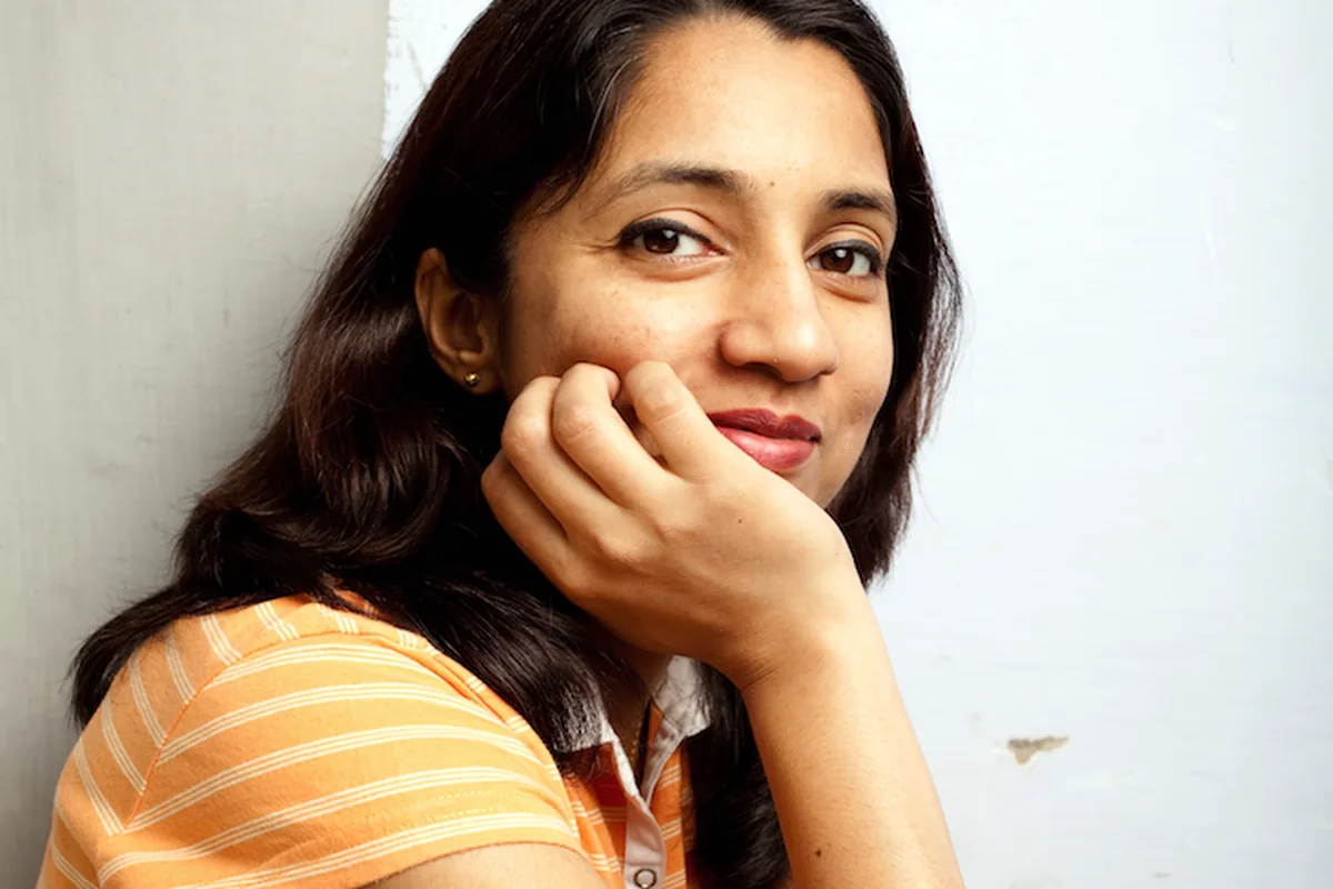 A woman resting her chin on her hand with a calm, reflective expression