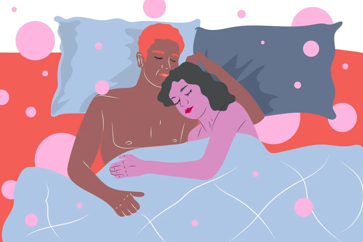 Flat illustration of a couple cuddling asleep facing each other in bed under a light-blue blanket against a coral headboard with pink dots