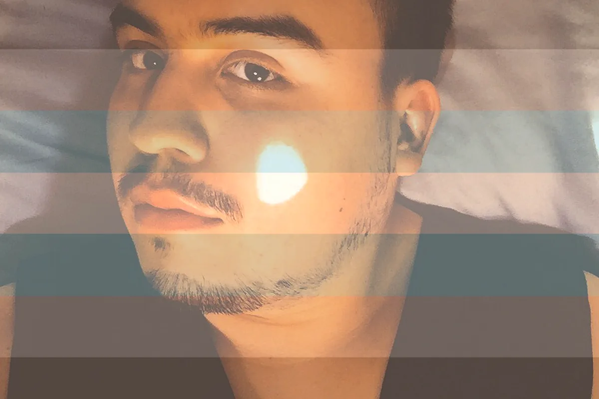 A man’s face overlaid with soft horizontal stripes of colour