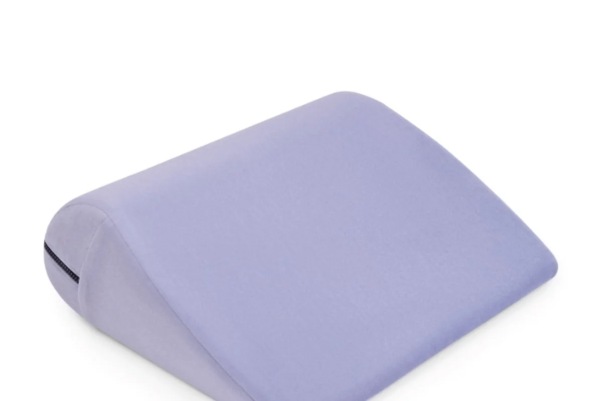 A lavender wedge cushion on a white background