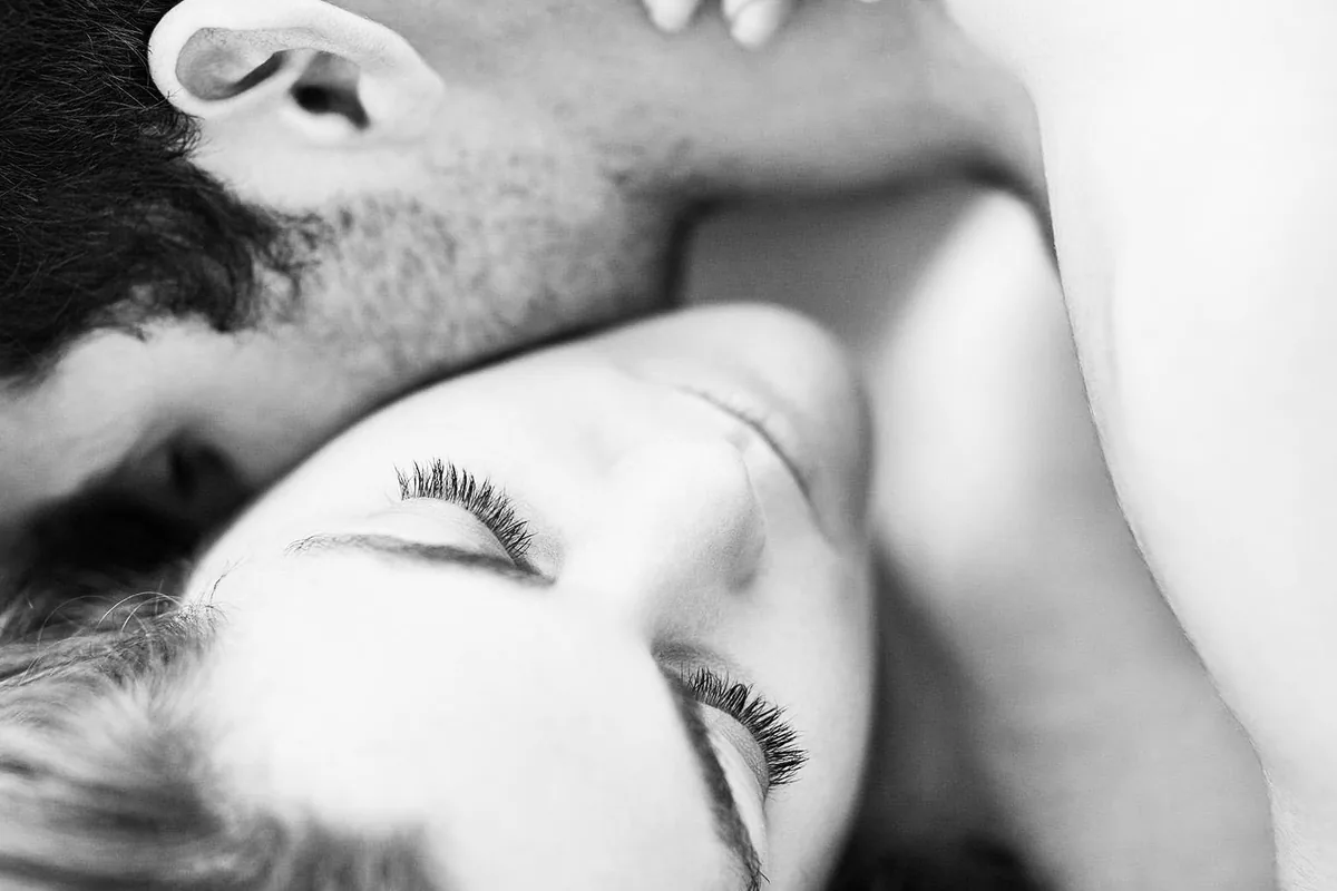 Black-and-white close-up of a couple embracing, faces together